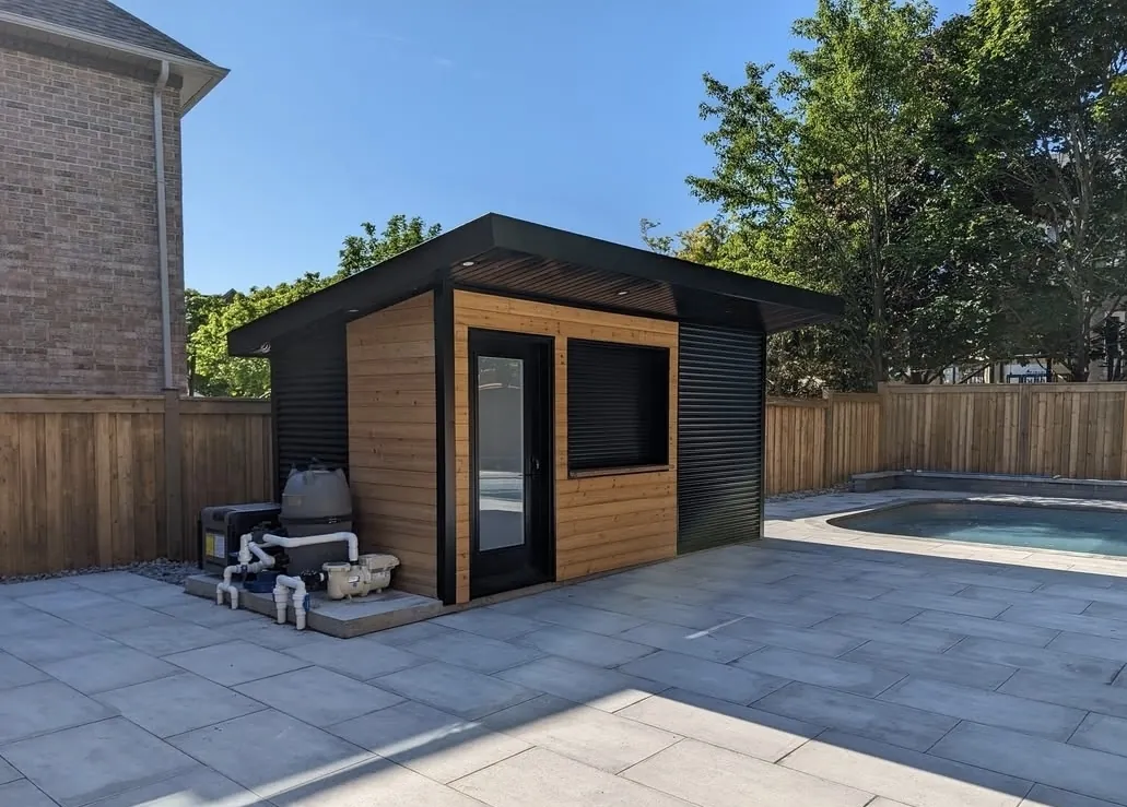 Modern backyard studio with black cladding and cedar