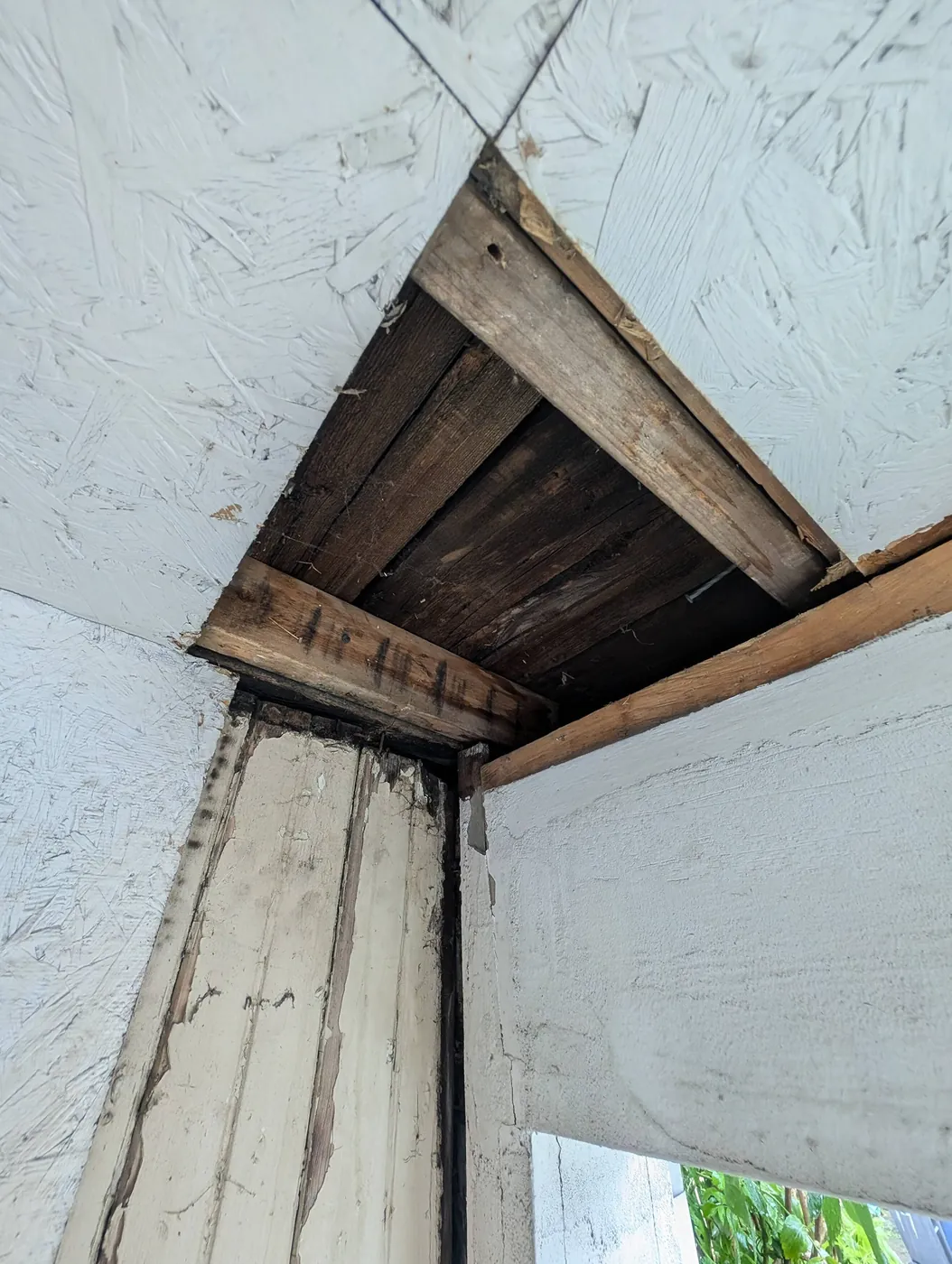 Rotted framing uncovered during demolition, a common hidden cost